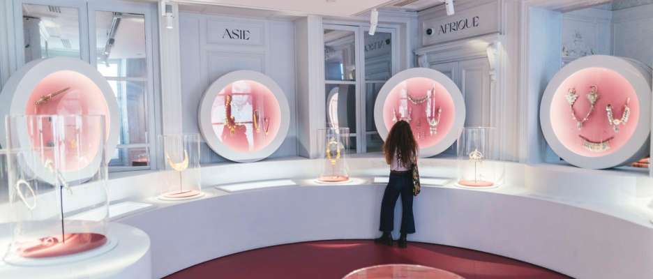 Woman seen from behind looking at the collections of the Monnaie de Paris Museum
