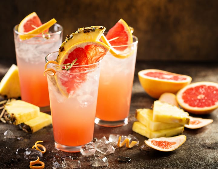 Three grapefruit and pineapple cocktails