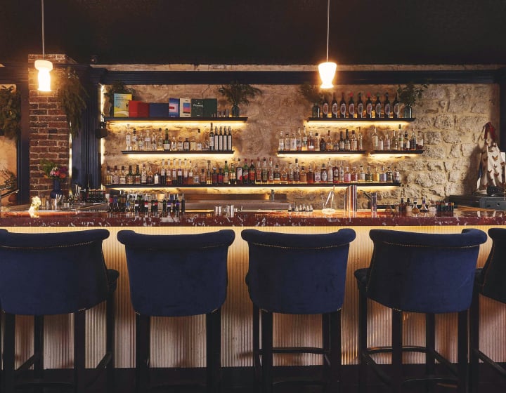 Little Red Door bar counter with midnight blue bar chairs