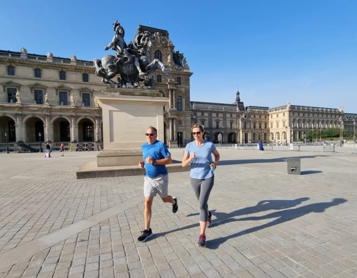 Un homme et une femme courant aux abords du Louvre