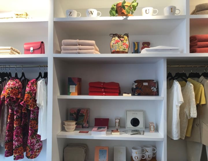 Sézane boutique department with clothes, bags, mugs and books