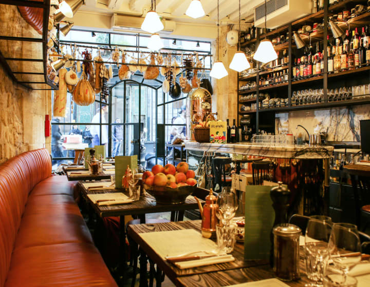Intérieur du restaurant BigLove Caffé, ambiance bistrot avec jambons suspendus à l'entrée