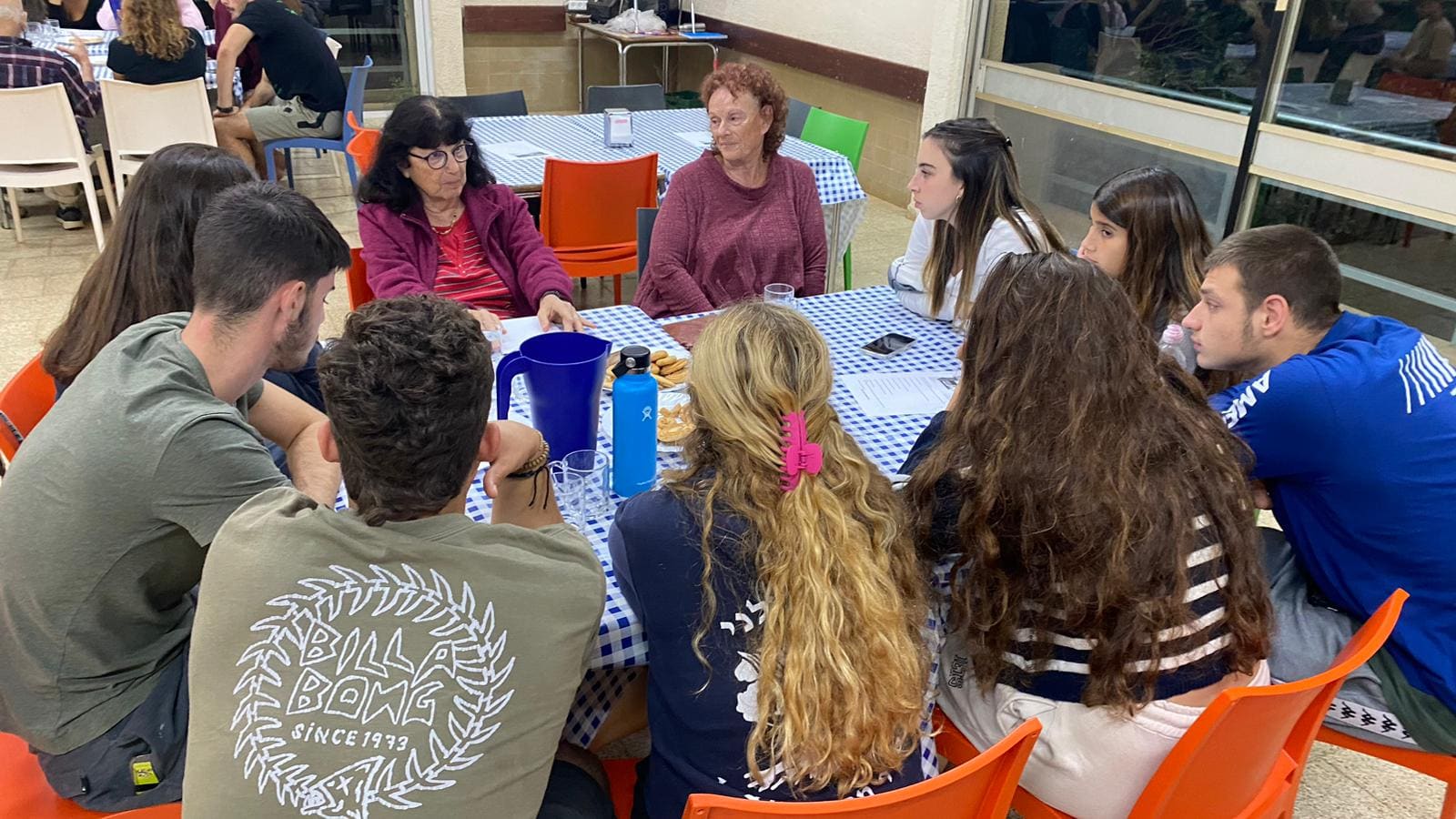Three participants working on a shared garden for the Kibbutz.