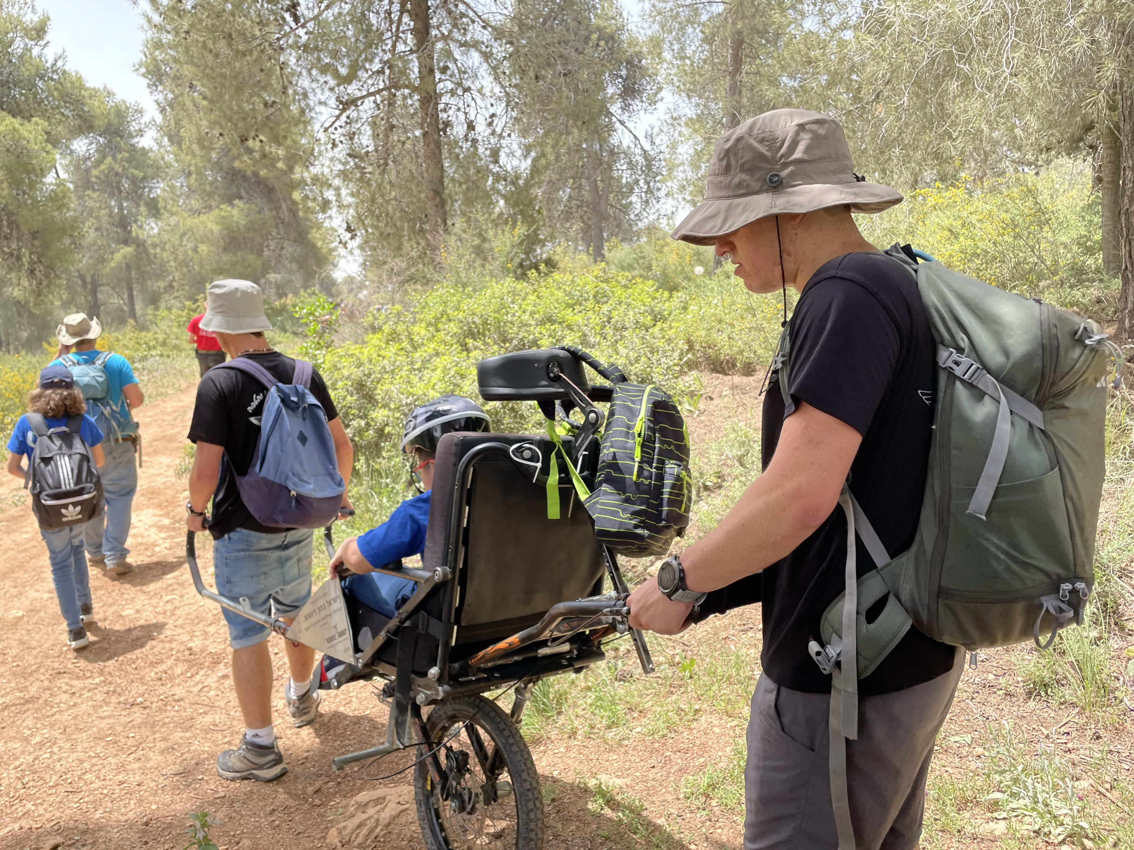 Three participants working on a shared garden for the Kibbutz.