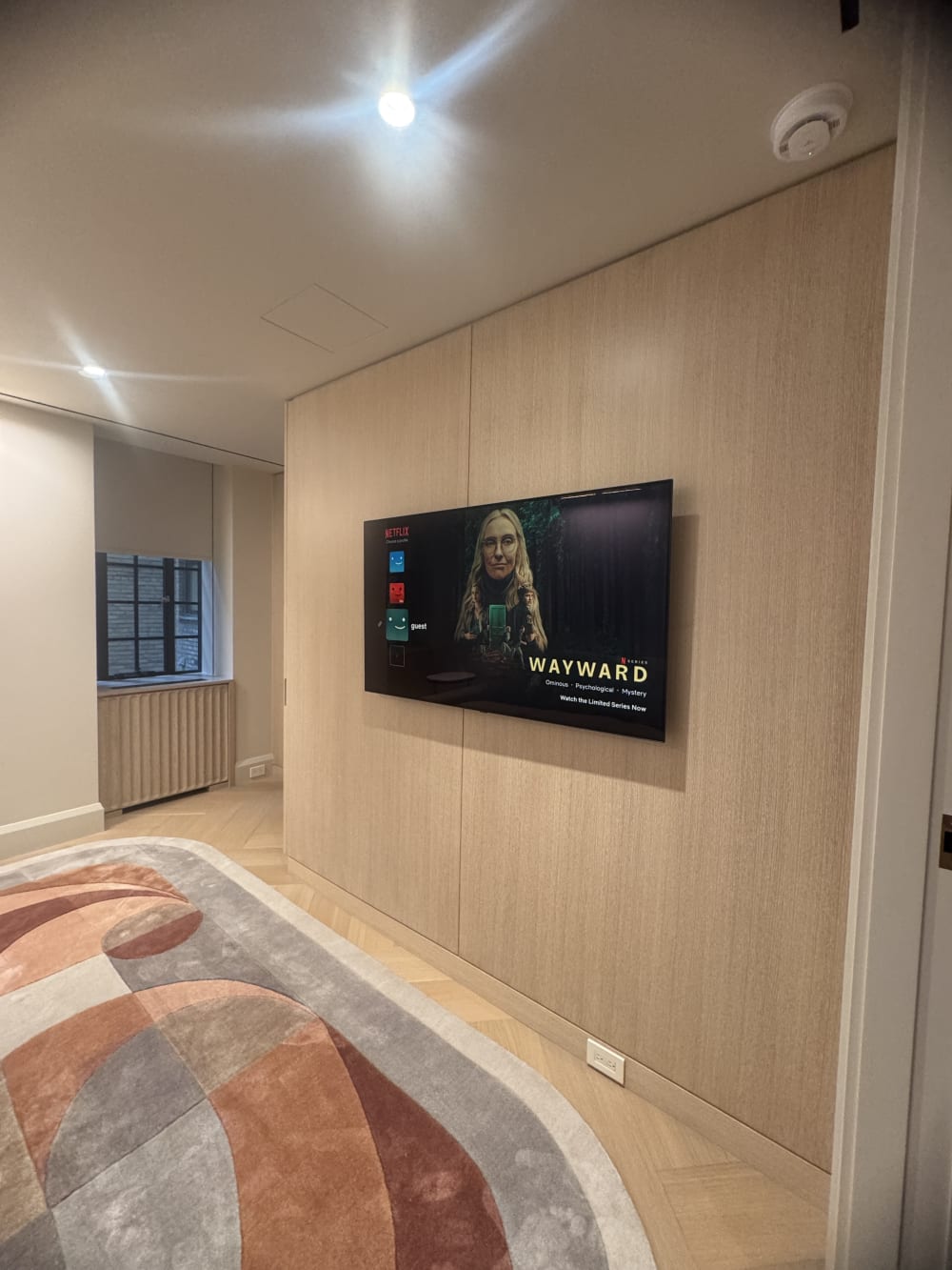 Wall-mounted television integrated into a tailored Manhattan media room