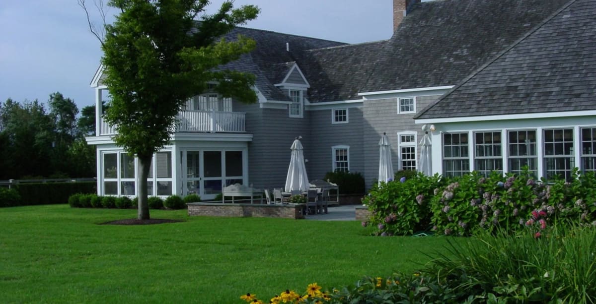 Architectural exterior of a finished residence, illustrating discreet technology planning for waterfront homes