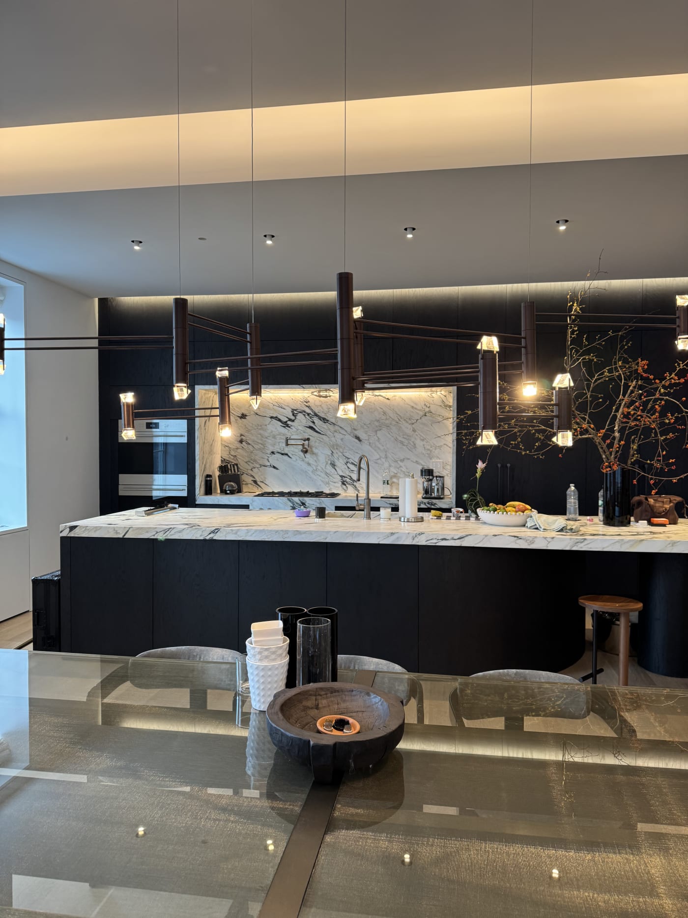Modern Manhattan apartment kitchen with integrated lighting and smart home technology by HTE