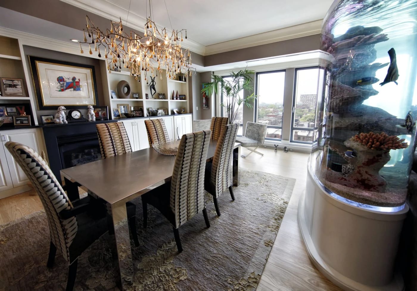 Luxurious dining room with chandelier and large windows, controlled by Control4