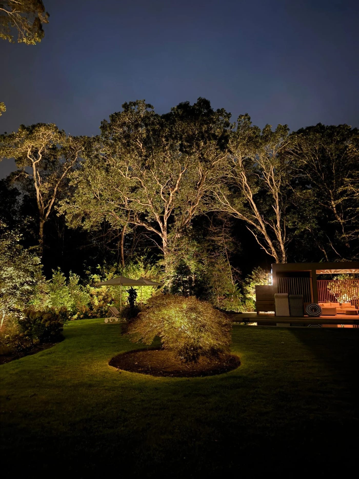 Amagansett landscape with discreet exterior lighting integrated around the coastal property