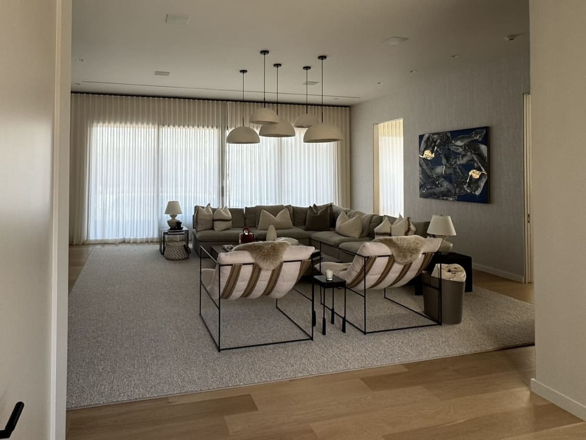Layered recessed lighting and motorized shades in a luxury home designed by HTE