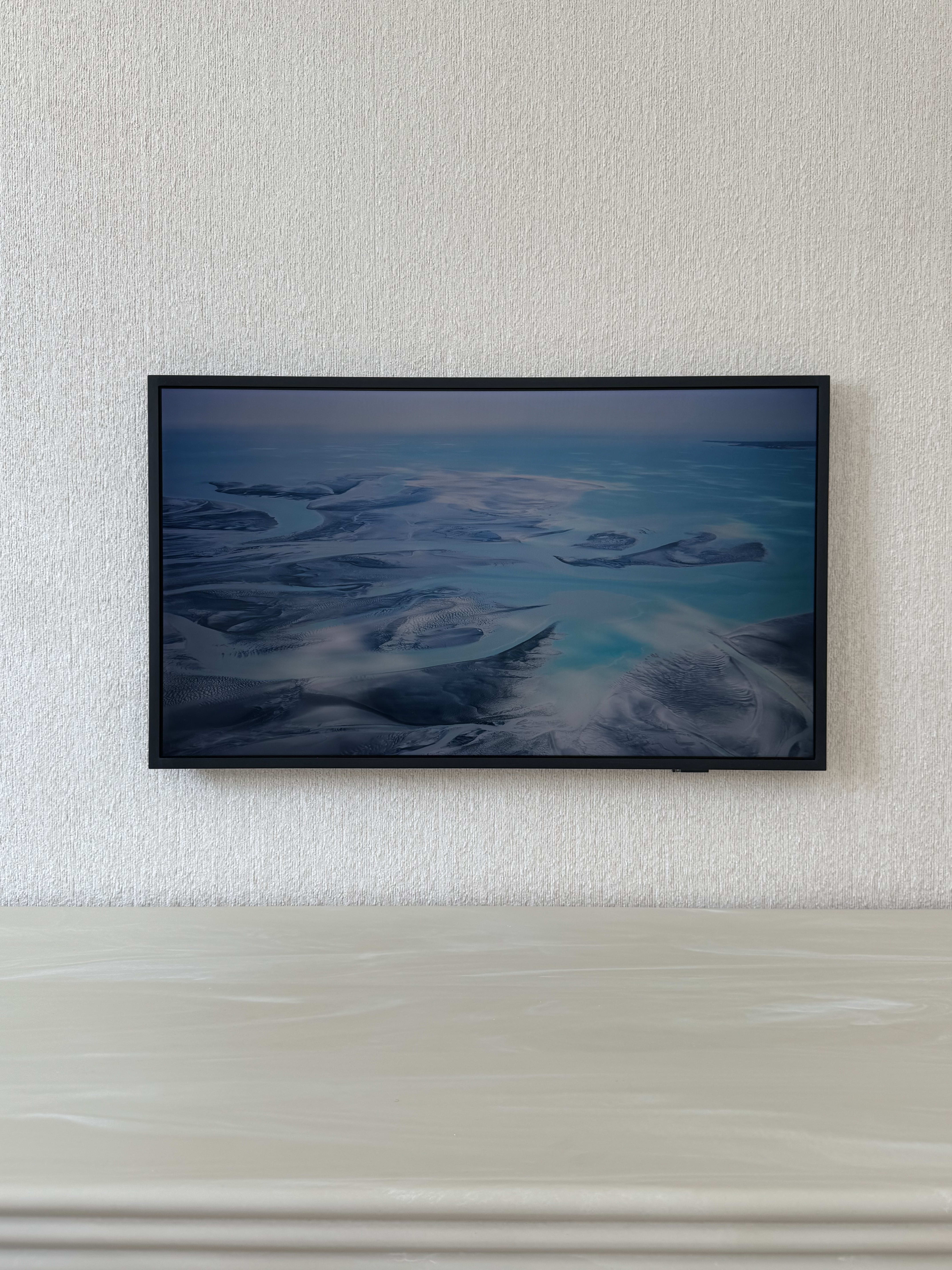 Wall-mounted television in a finished contemporary living room