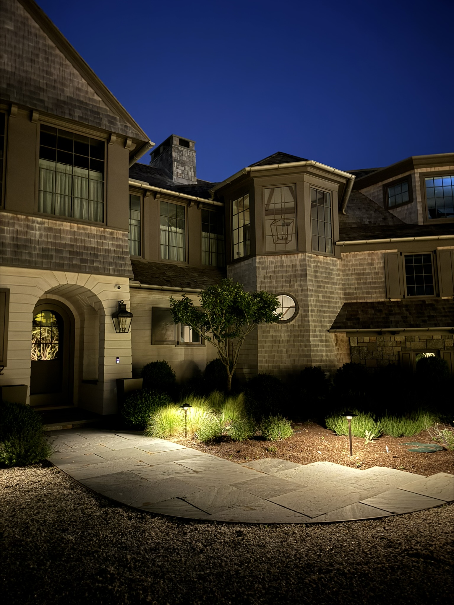 Discreet landscape lighting illuminating a residential exterior