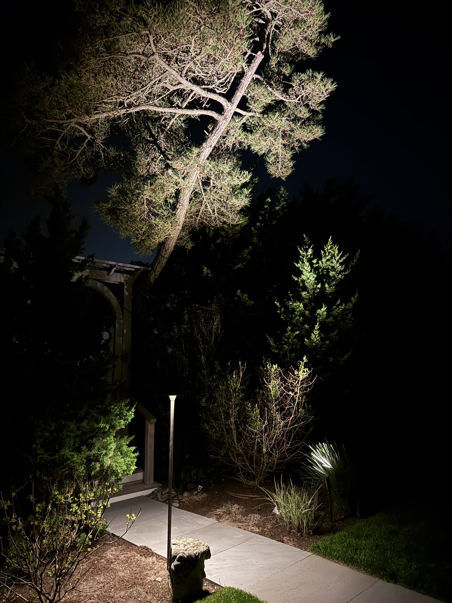 Hamptons residence with warm landscape lighting at dusk