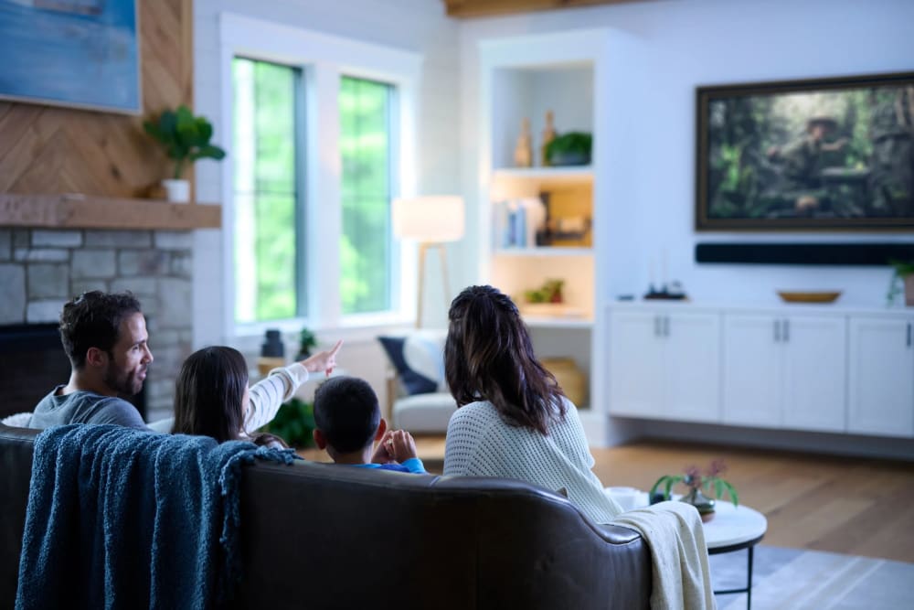 Savant smart home living room — family enjoying integrated AV and lighting