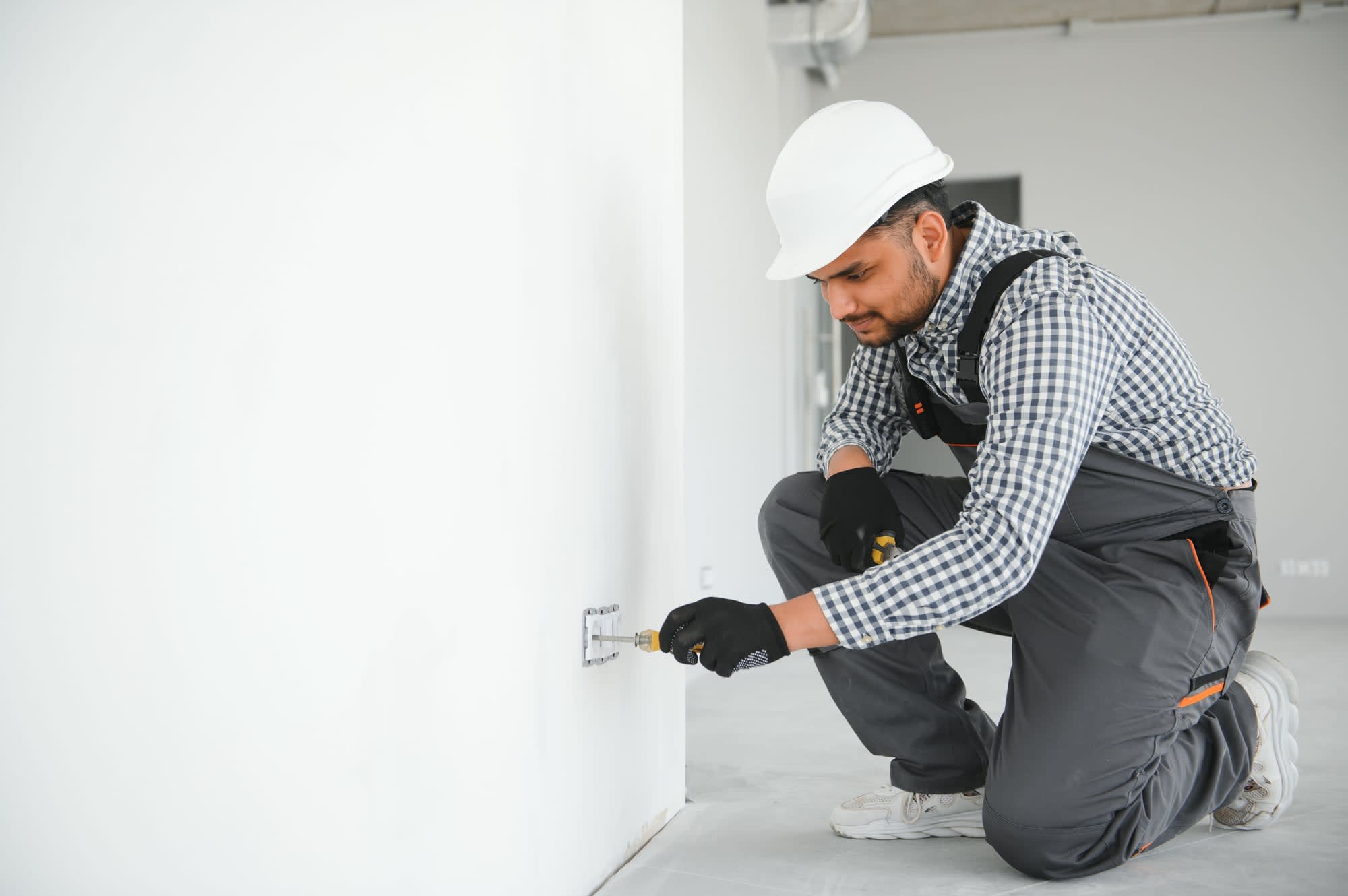 Installation d'une prise électrique murale par un électricien partenaire