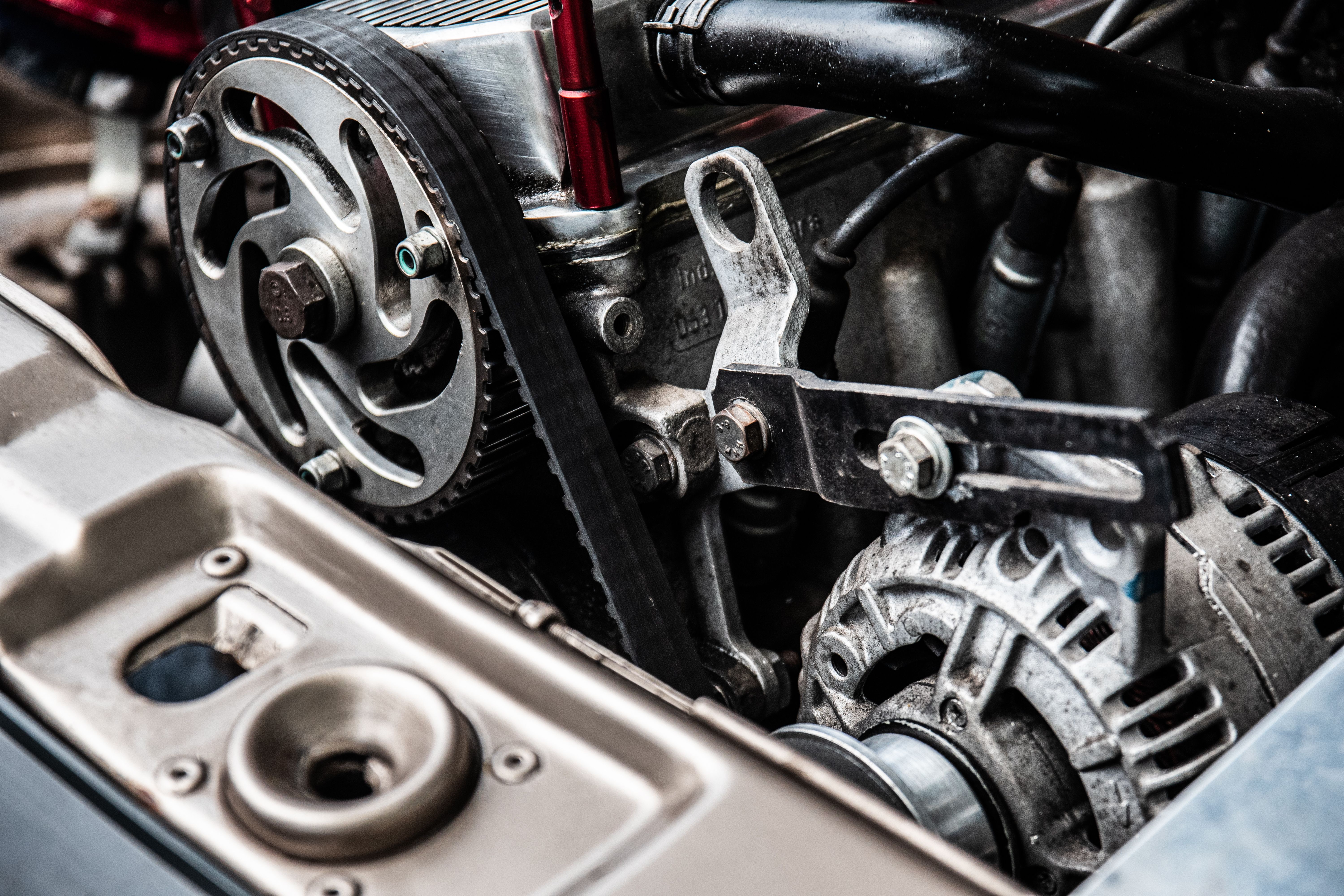 automotive mechanic installing alternator