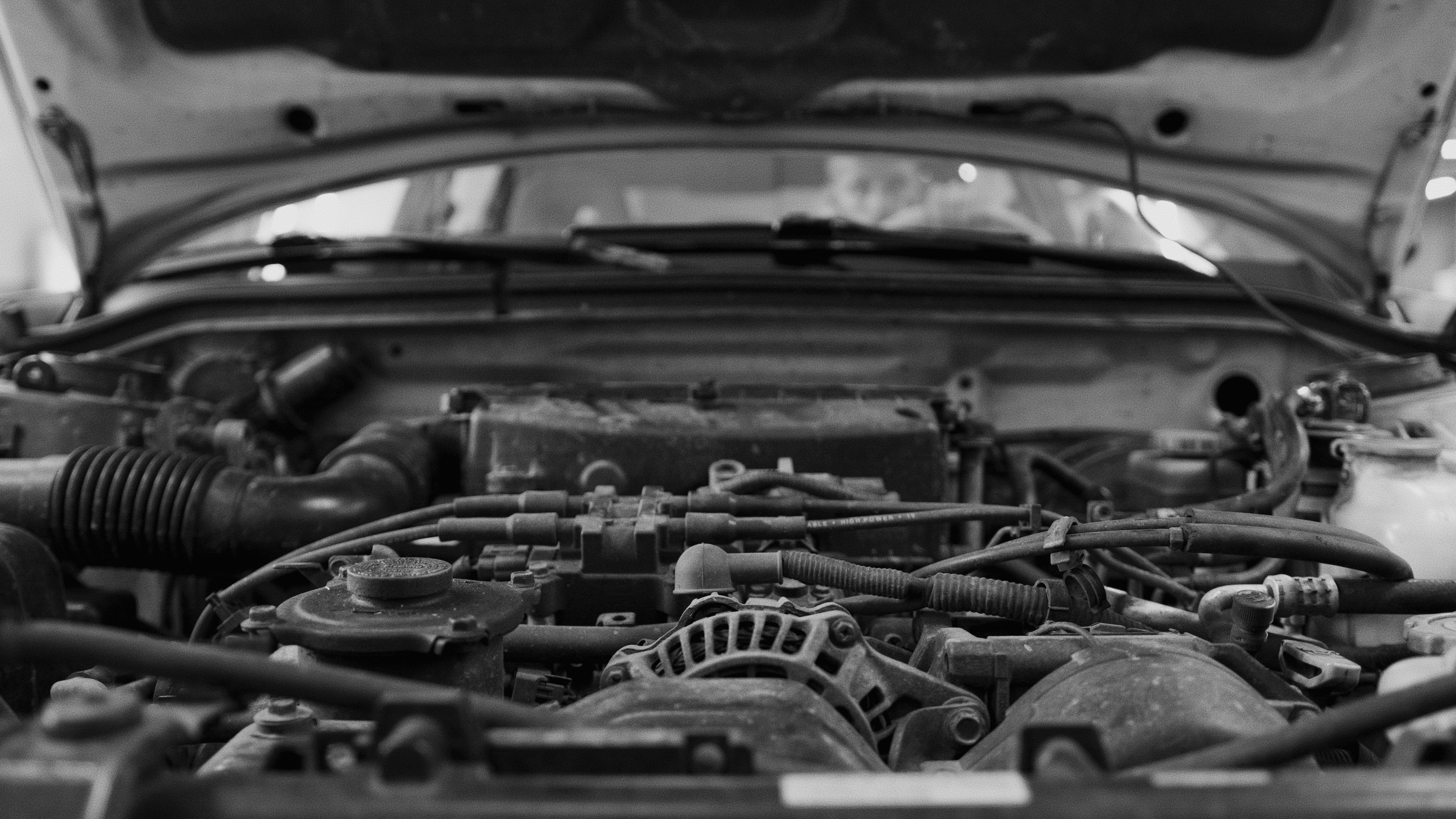 mechanic replacing alternator car engine