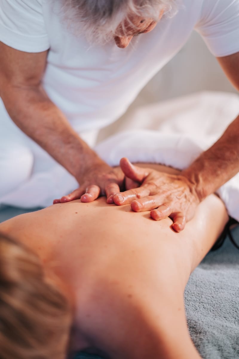 A masseur provides a relaxing massage, promoting wellness in the serene atmosphere of Glemmtal.