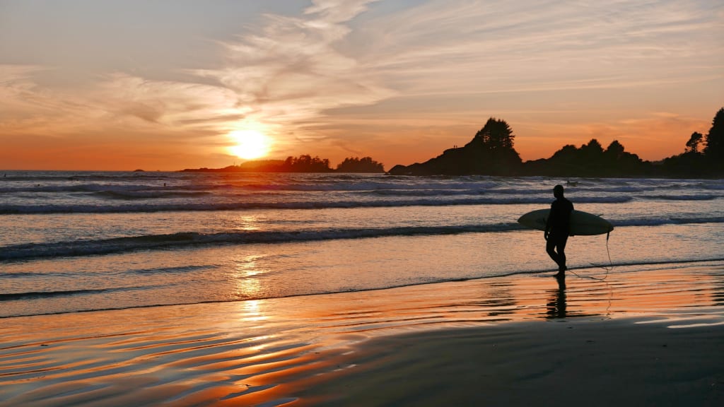sunset surfer with surfboard tofino