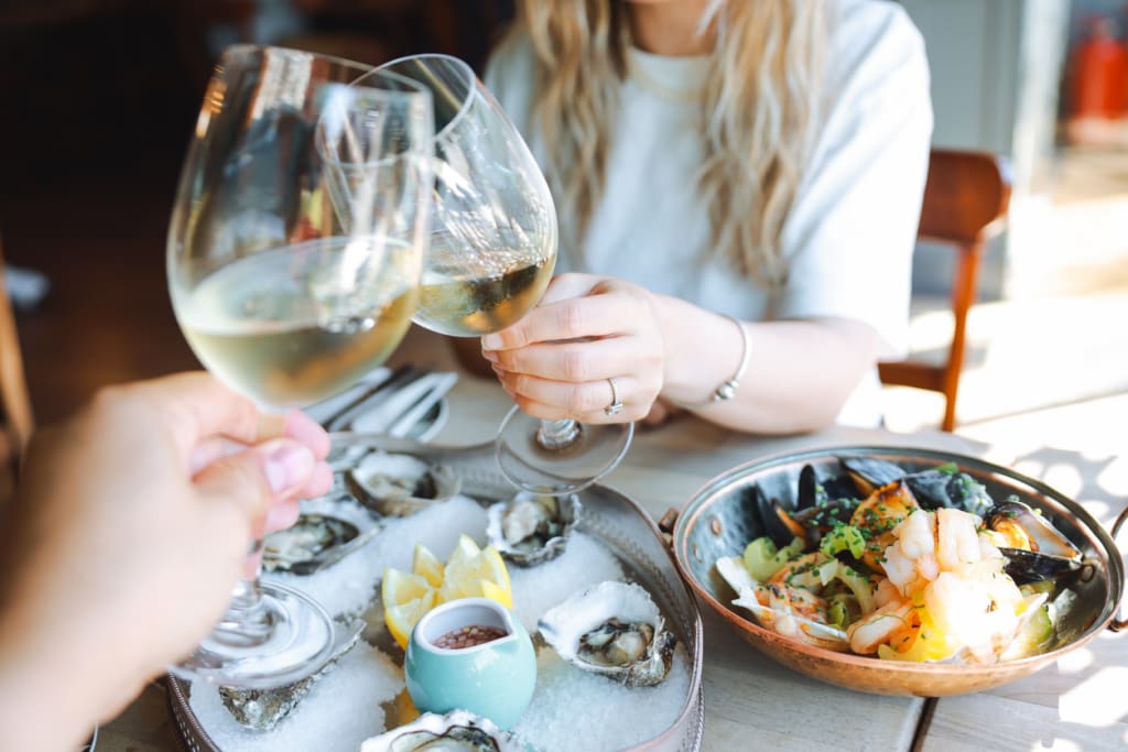 Fresh oysters and seafood shared over white wine