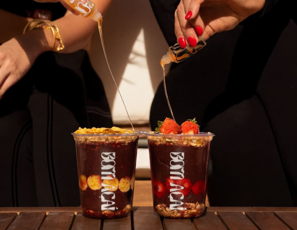 Rainforest honey drizzled over two Bom Açaí cups