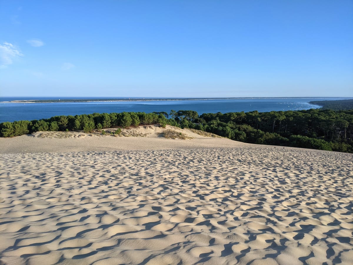 The calm sea, sheltered by a sandbar.