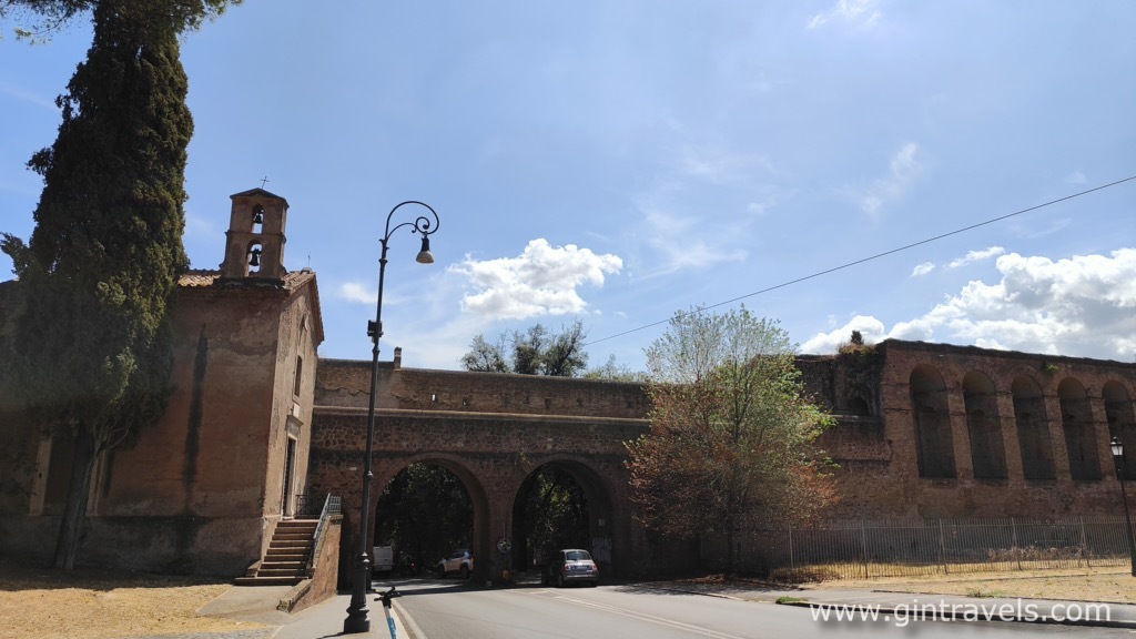 Aurelian walls with Chiesa di Santa Maria del Buon Aiuto nell' Anfiteatro Castrense with a bell tower