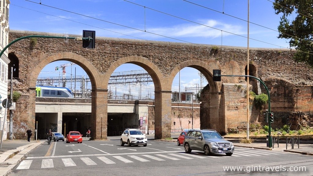 Fast train visible coming from Termini behind Porta Magiore