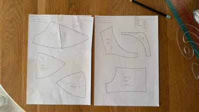 Draft 3 v6 pattern pieces on paper: top cup, bottom front cup, bottom side cup, frame, bridge, and band