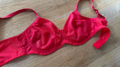 Finished red underwire bra laid flat, outside view