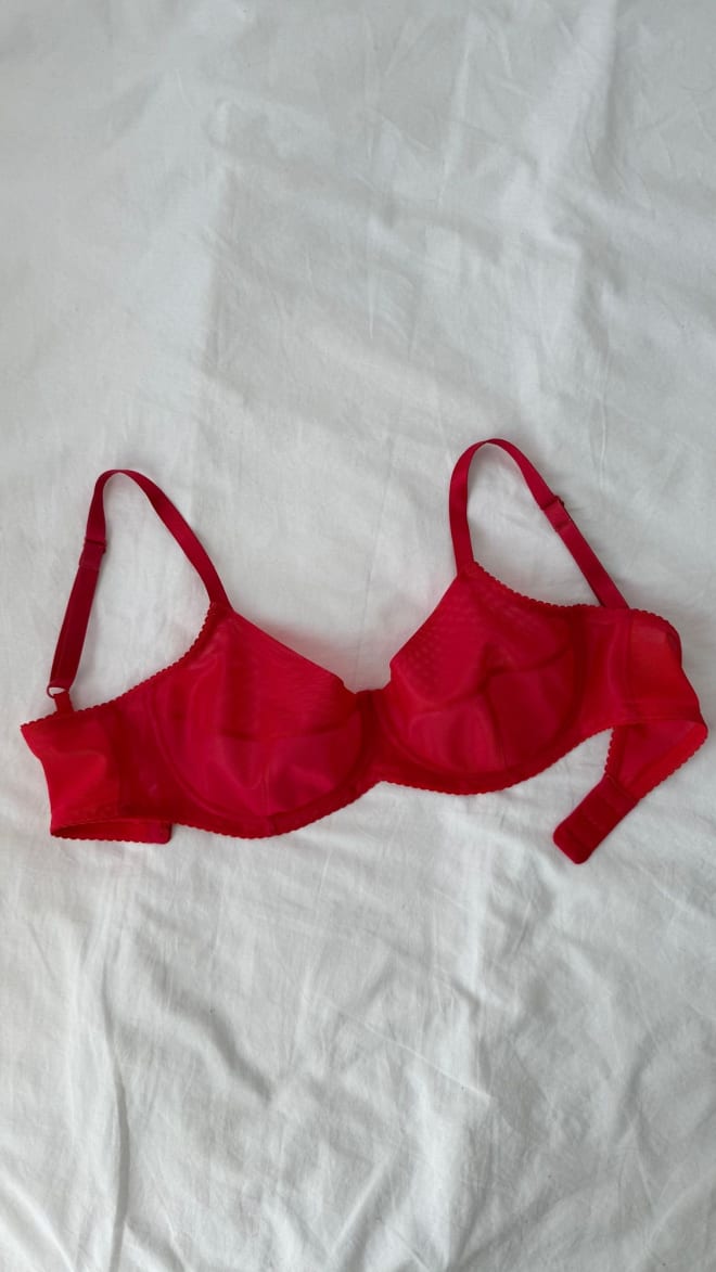 Finished red underwire bra laid flat on a white sheet
