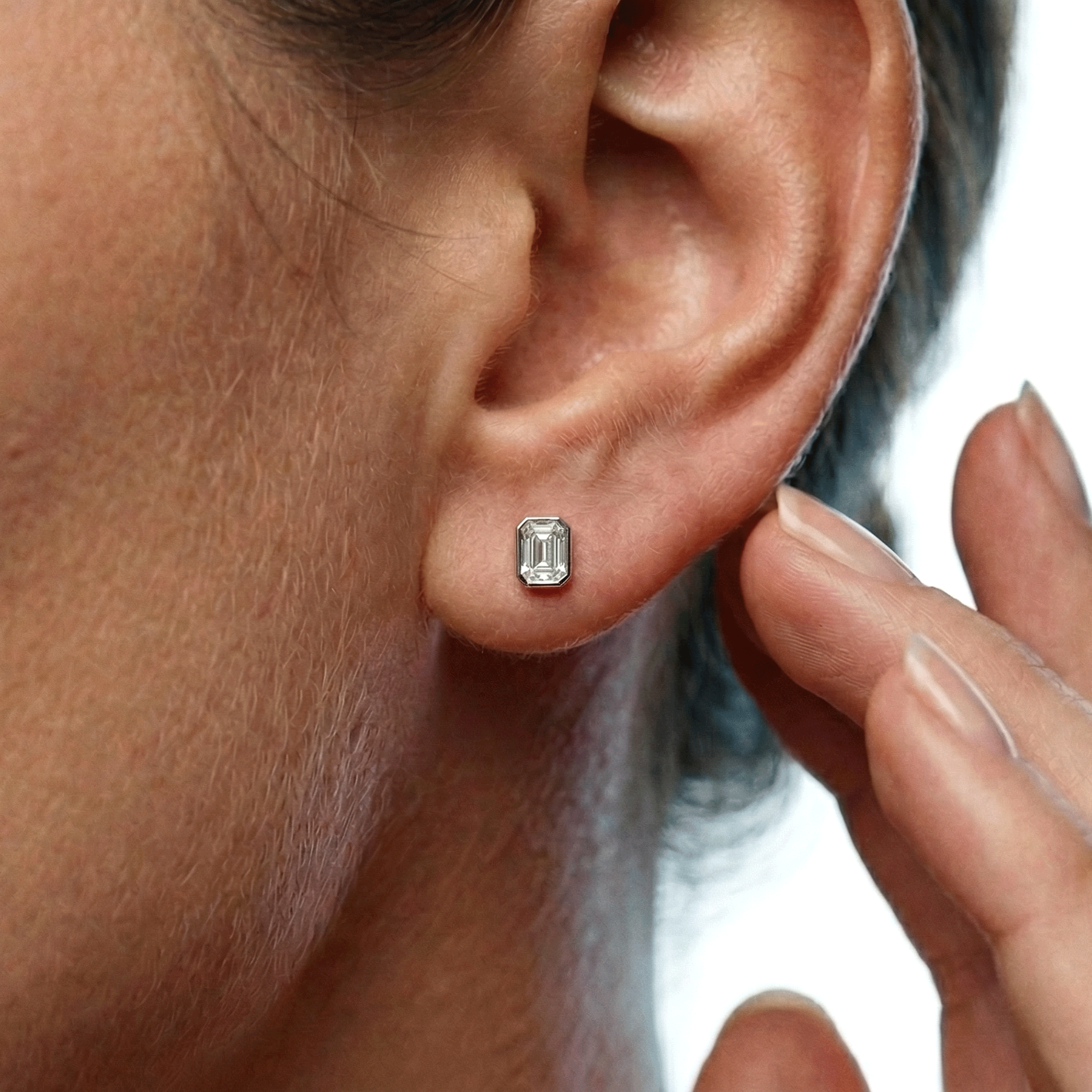 Valencia bezel emerald cut diamond stud earrings in white gold — earth and grown diamonds by Amber Arc – view 4