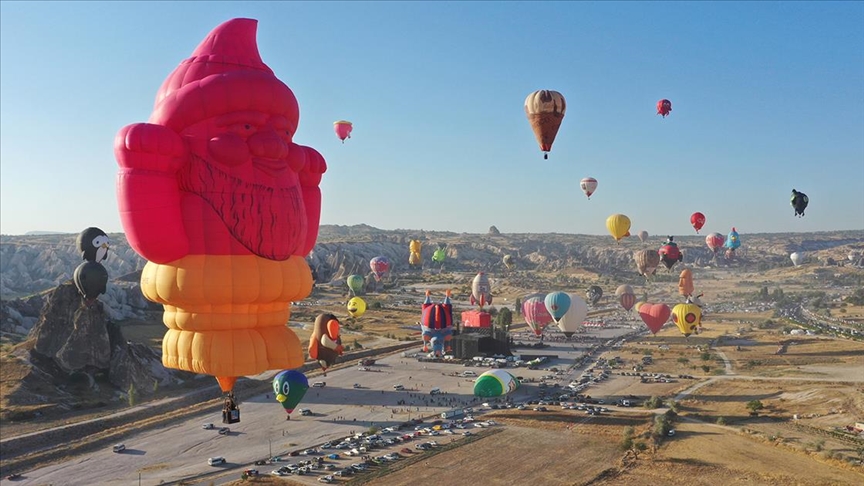 Colourful hot air balloons flying over Cappadocia during the Balloon Festival.