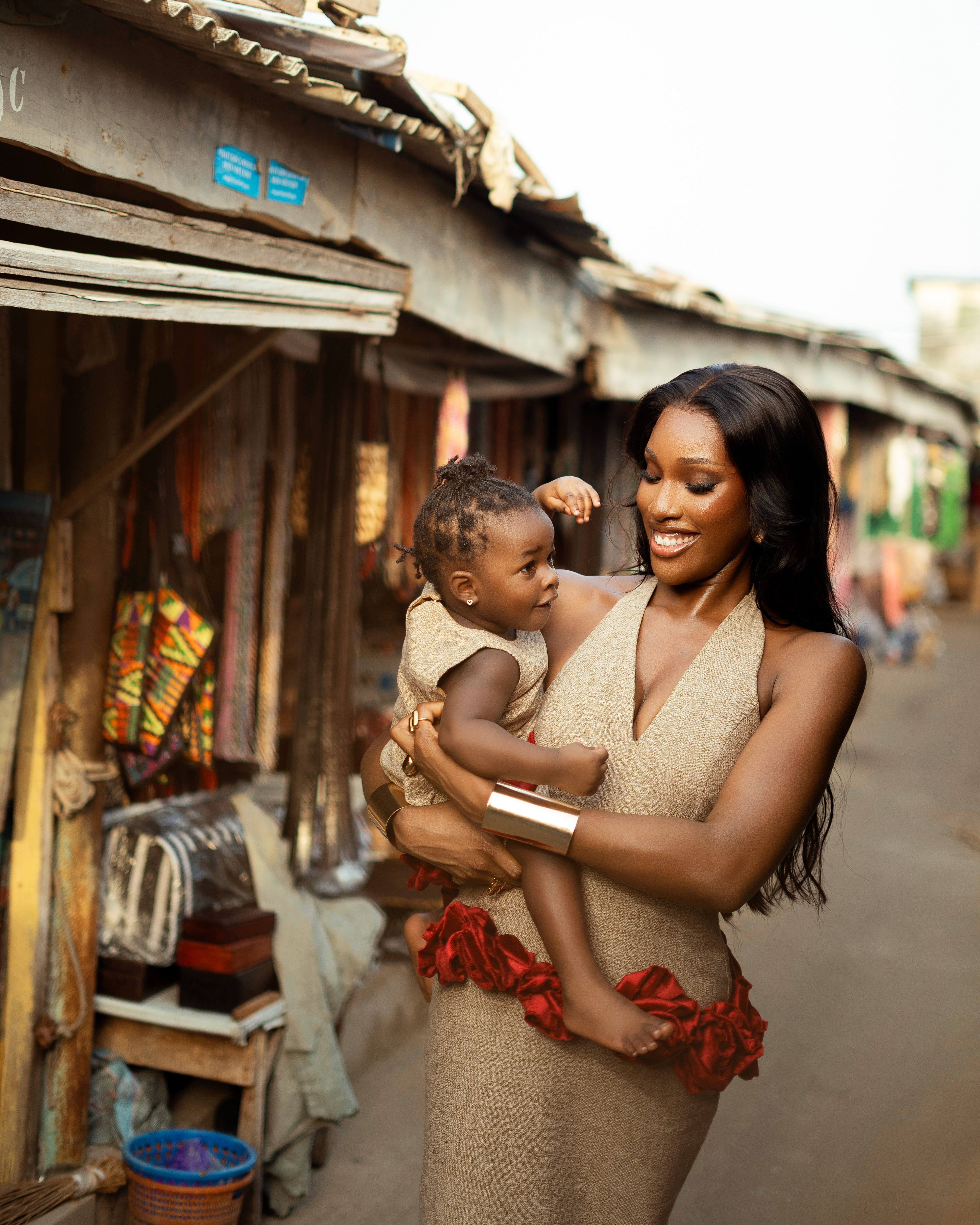 Mother and child in beige dress with red rose details