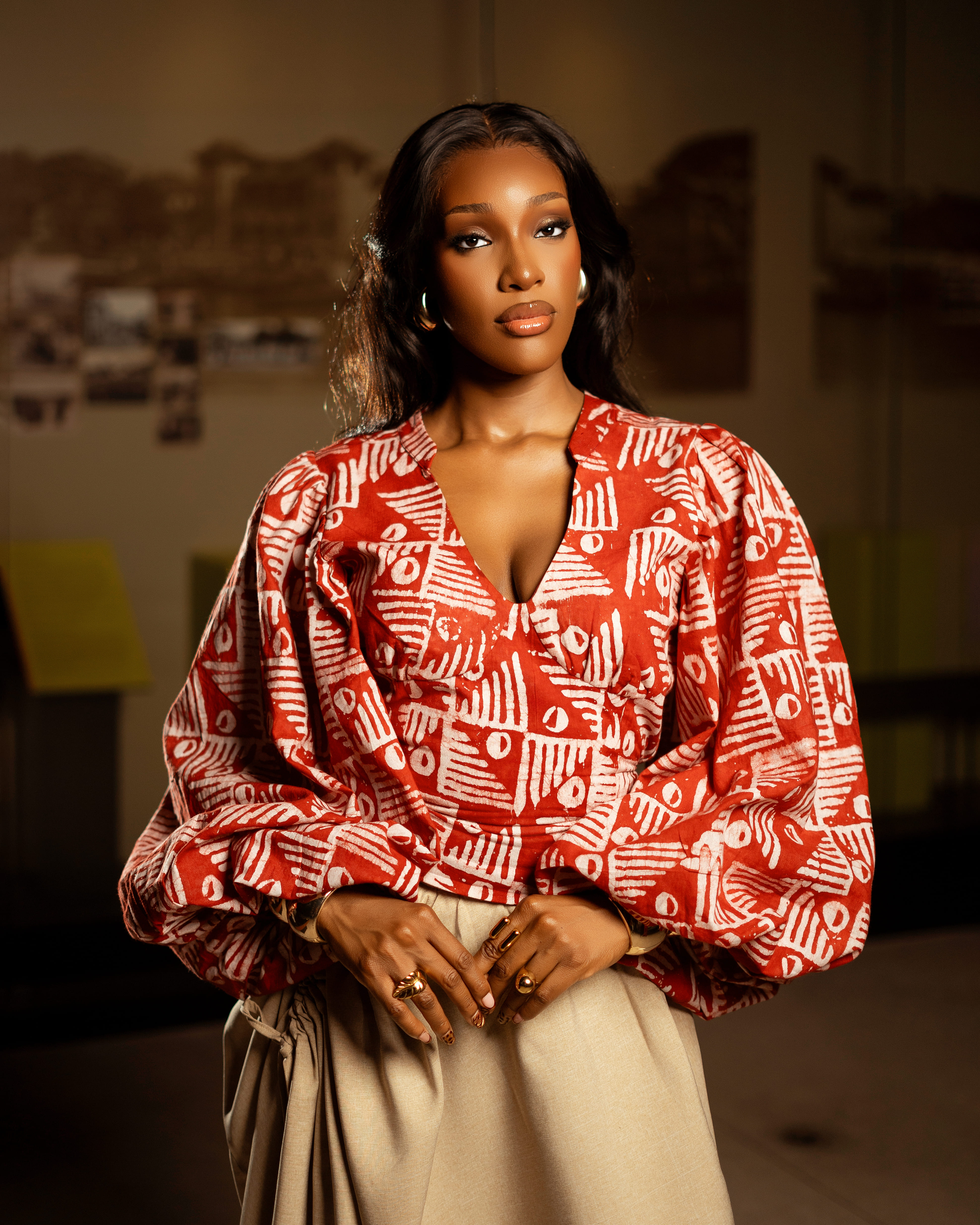 Model in beige halter dress with red rose details