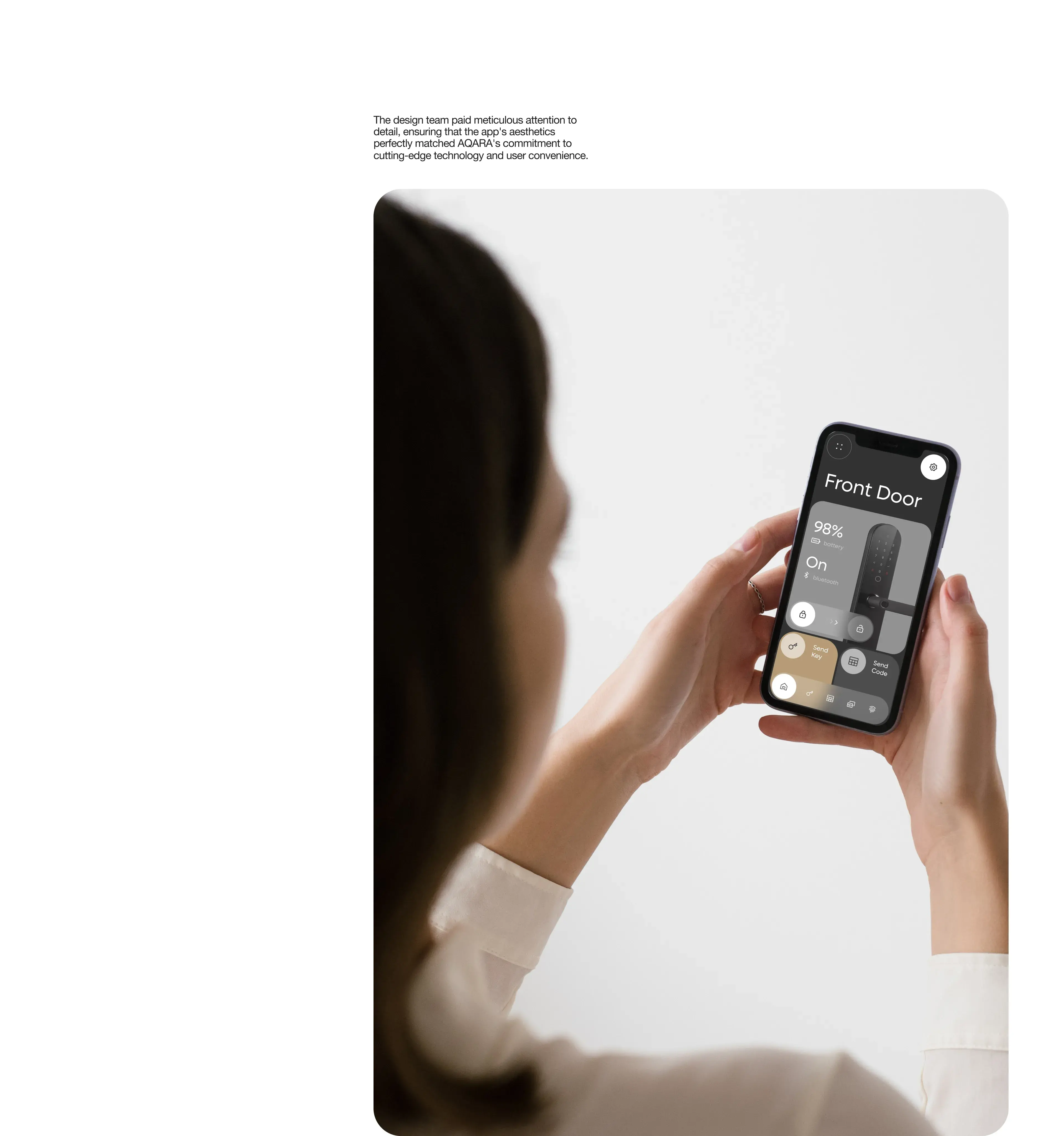 Hand holding an iPhone displaying a smart home control app interface.