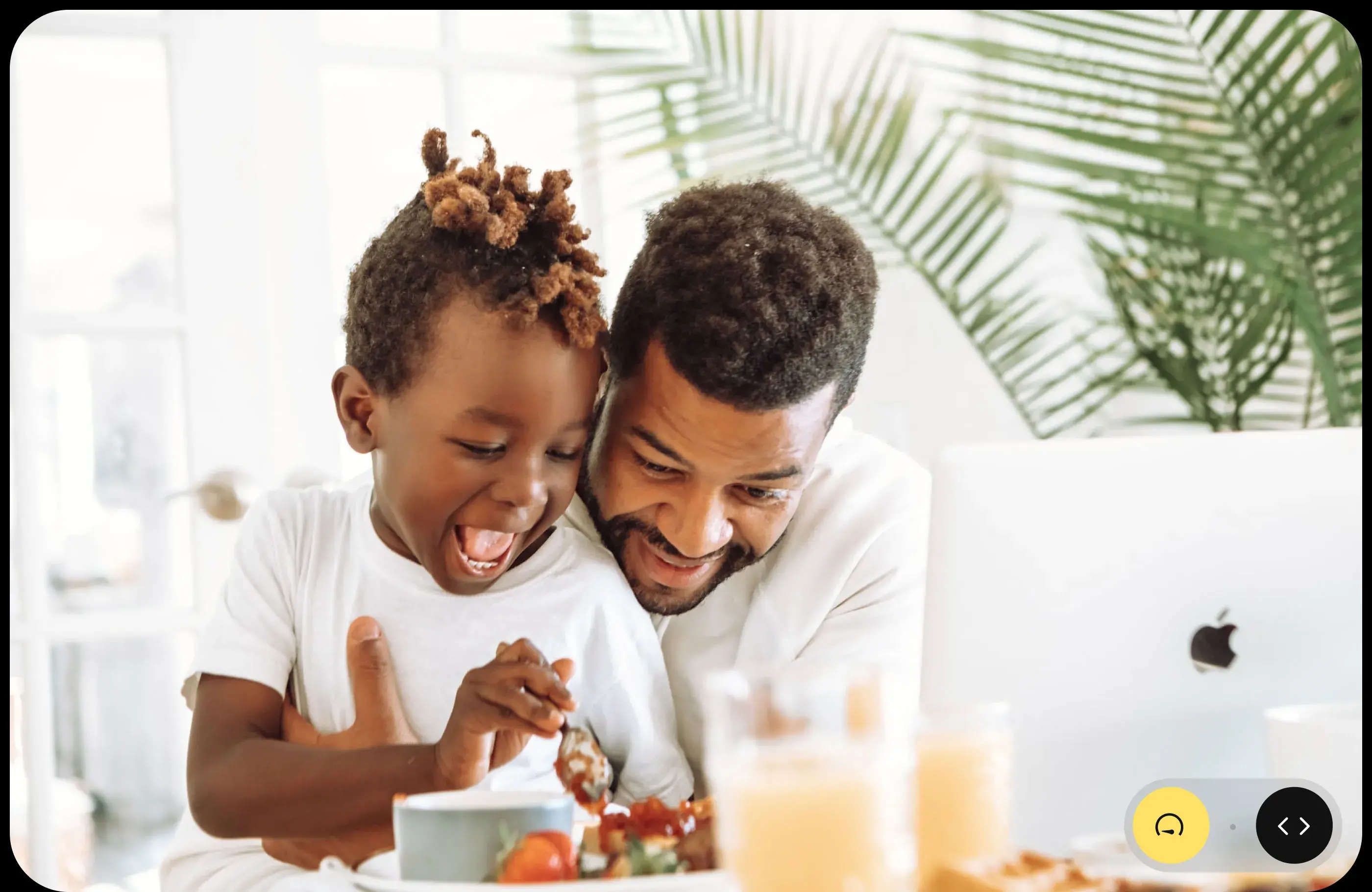 Father and child sharing a happy mealtime, a family moment supported by the app design.