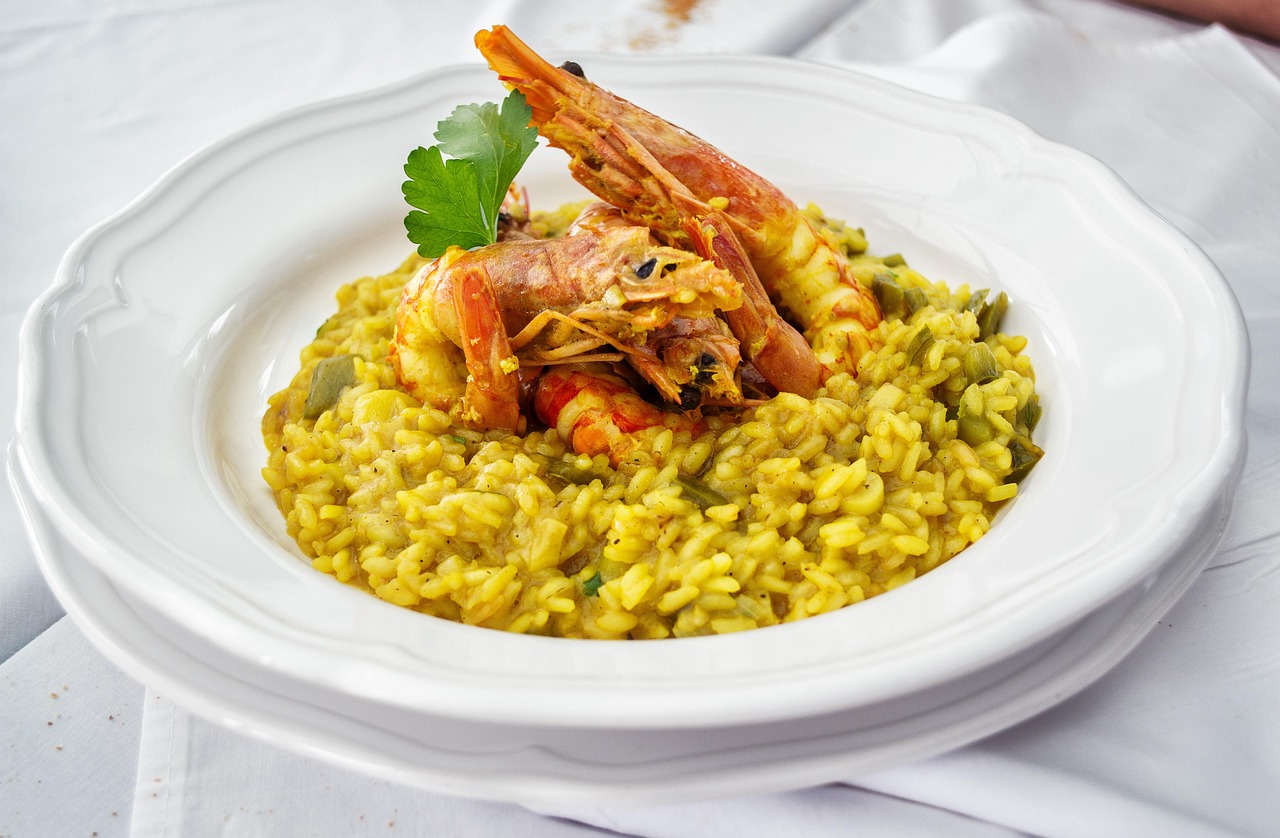 Creamy Arborio rice cooked with white wine, garlic, and herbs, topped with sautéed prawns and a touch of lemon zest.