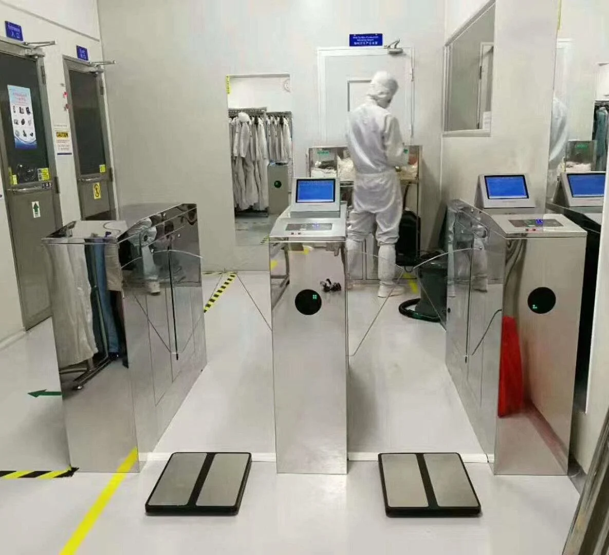 ESD flap barrier gate controlling cleanroom entry with worker grounding test and LED indicators for access approval or denial