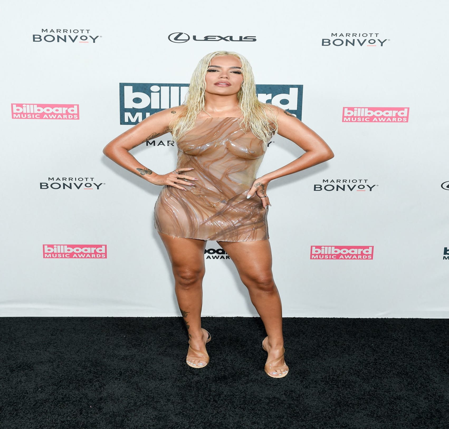 Daring to bare Karol G in her sheer beige latex two piece scaled e1700587343267