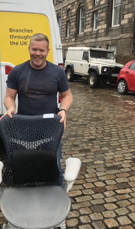 xDesign team member delivering desk chair and equipment to staff