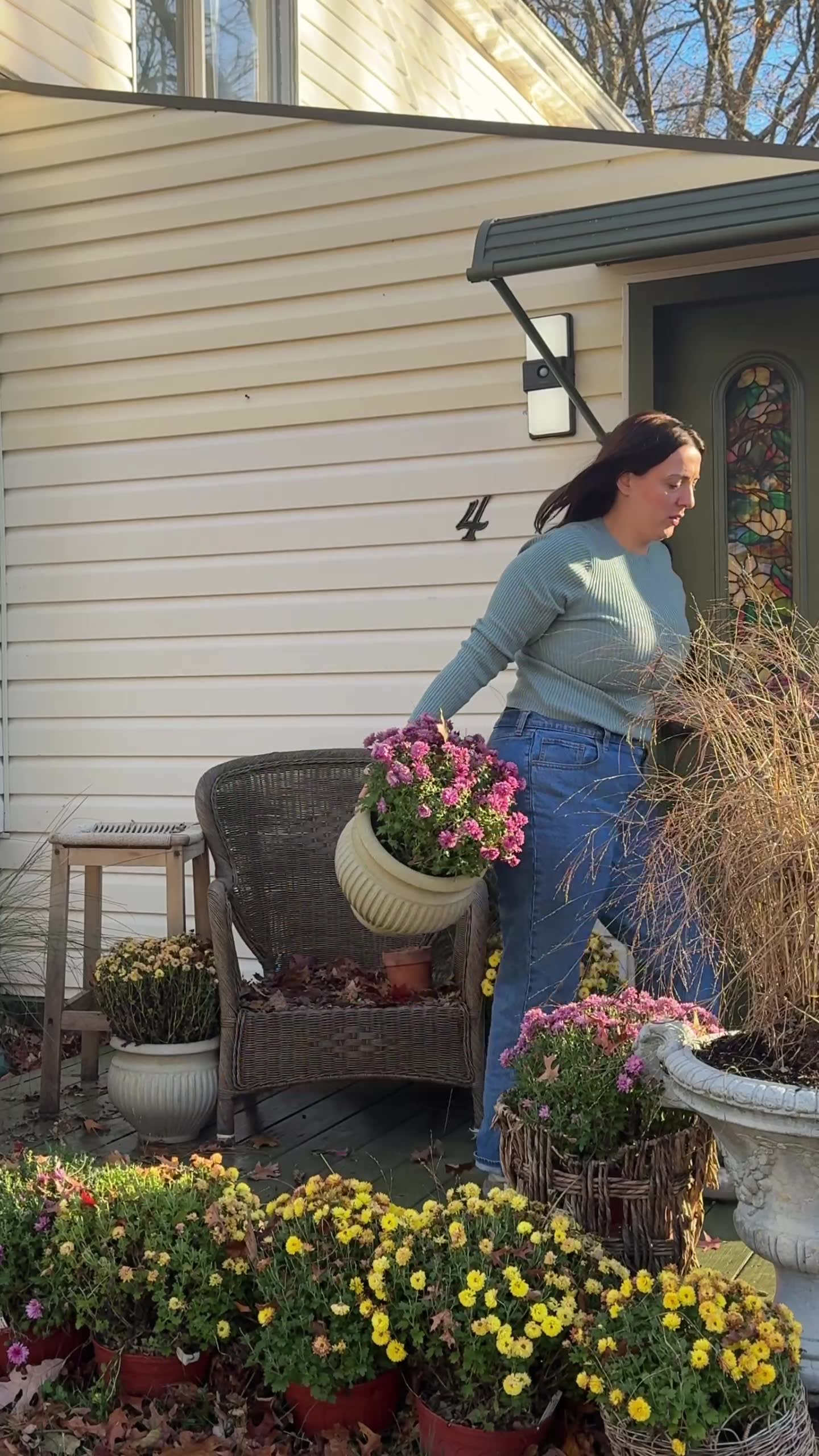 Medina on her front porch styled with fall mums