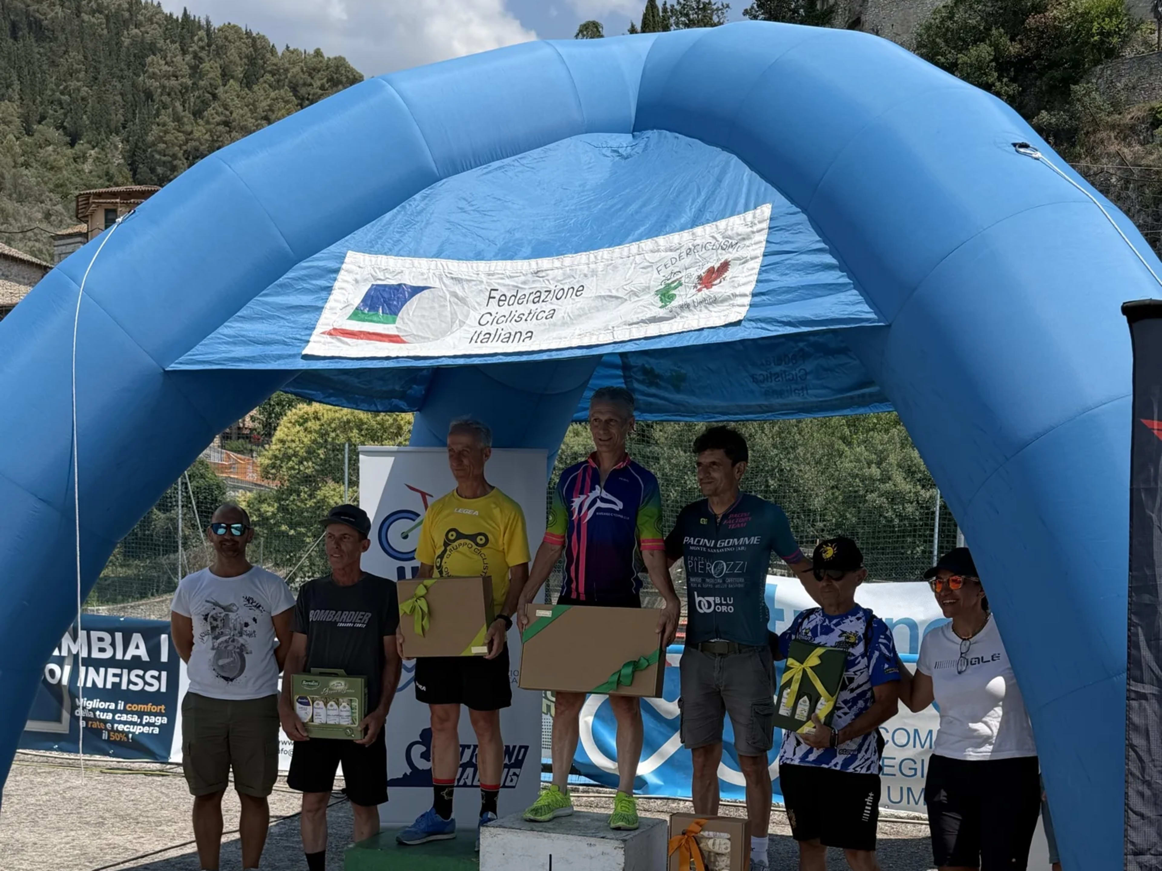 Cerimonia di premiazione con atleti e organizzatori attorno al podio