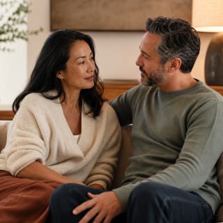 Couple in supportive conversation during online intimacy counseling