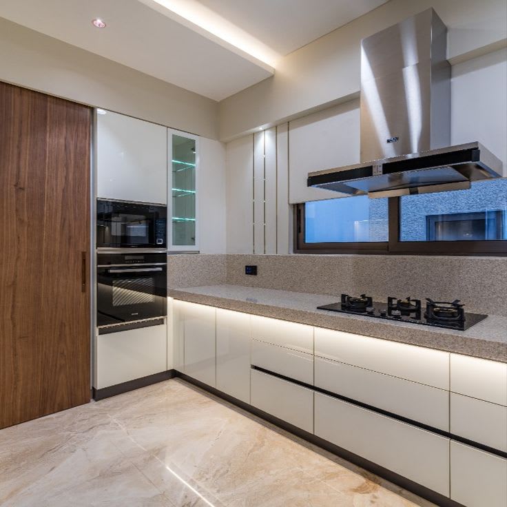 Bright modular kitchen with ceiling lighting and glossy finishes