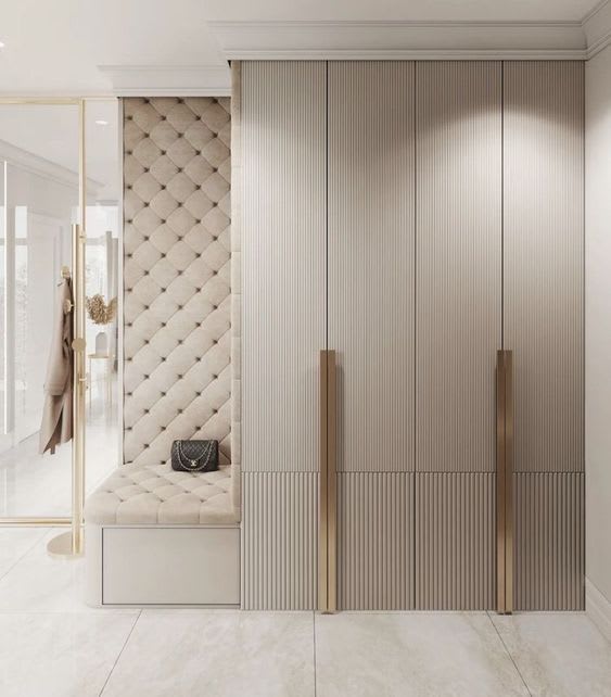 Walk-in wardrobe with glass panels and internal lighting