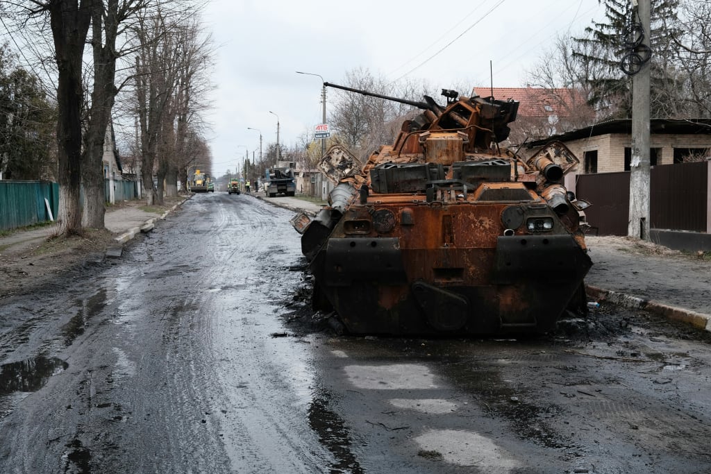 A Large Rusted out Tank Sitting on the Side of a Road