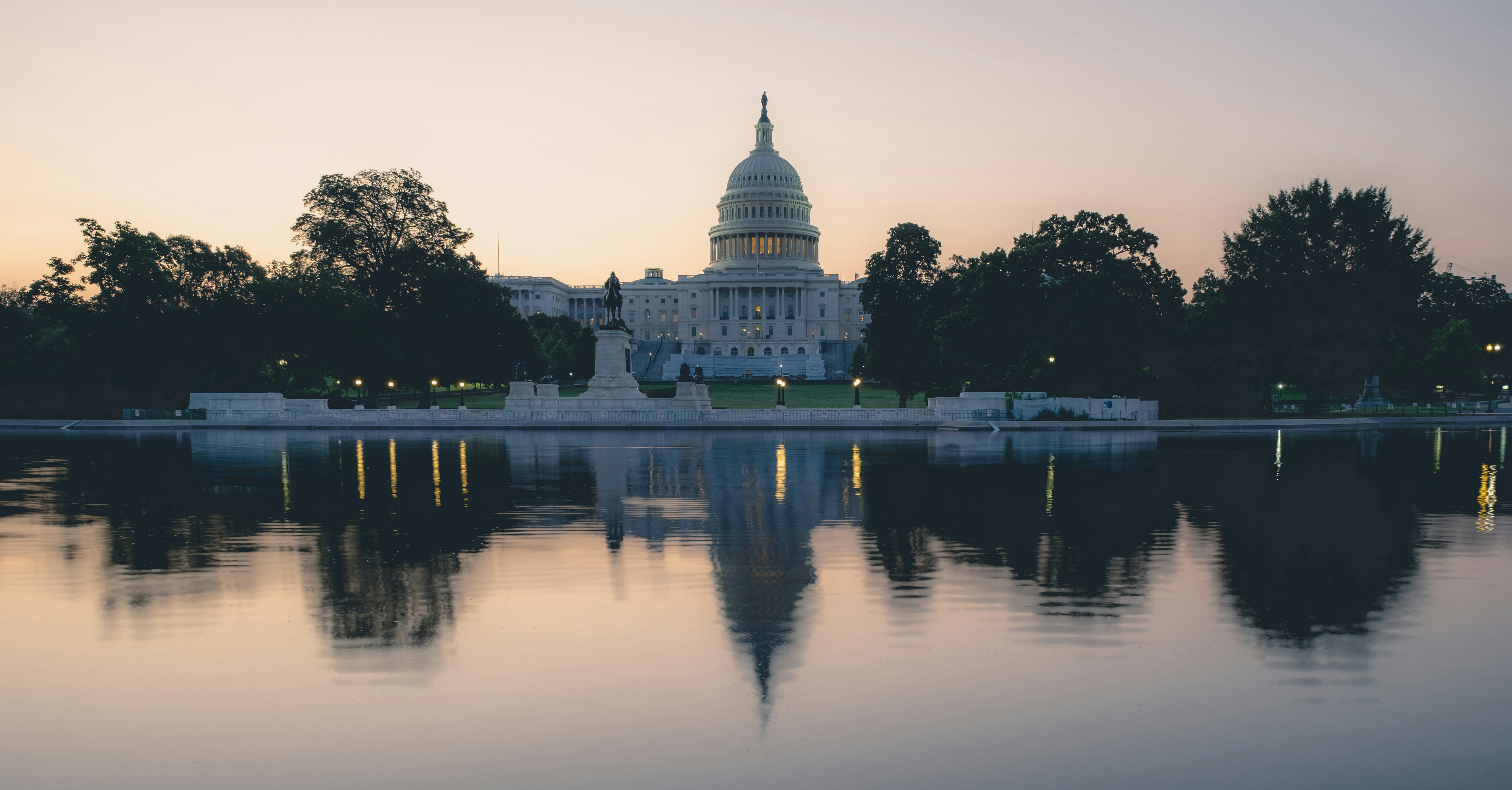 The U.S. Capitol is reflected in the water.