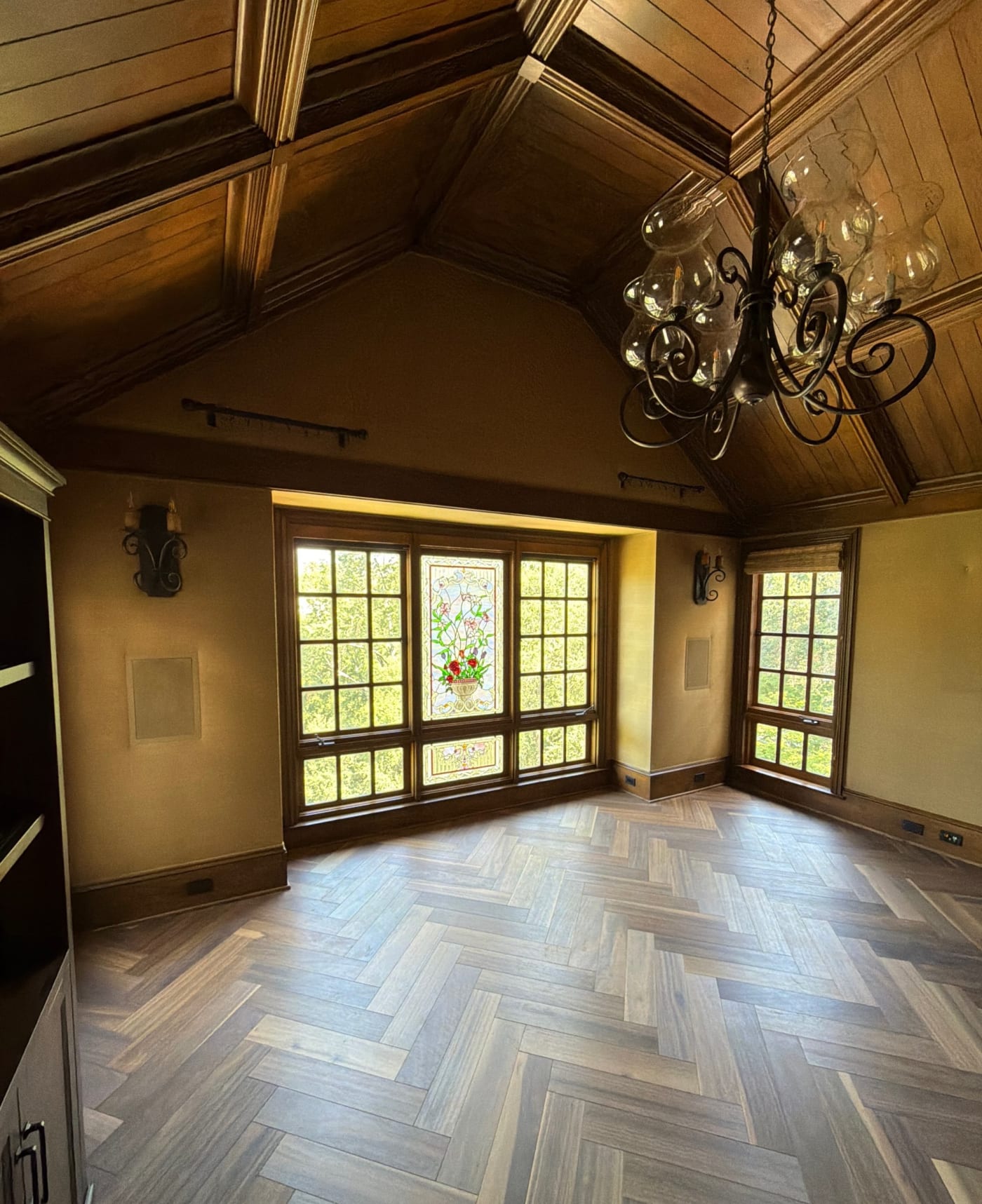 Library with a stained glass bay window and in wall speakers