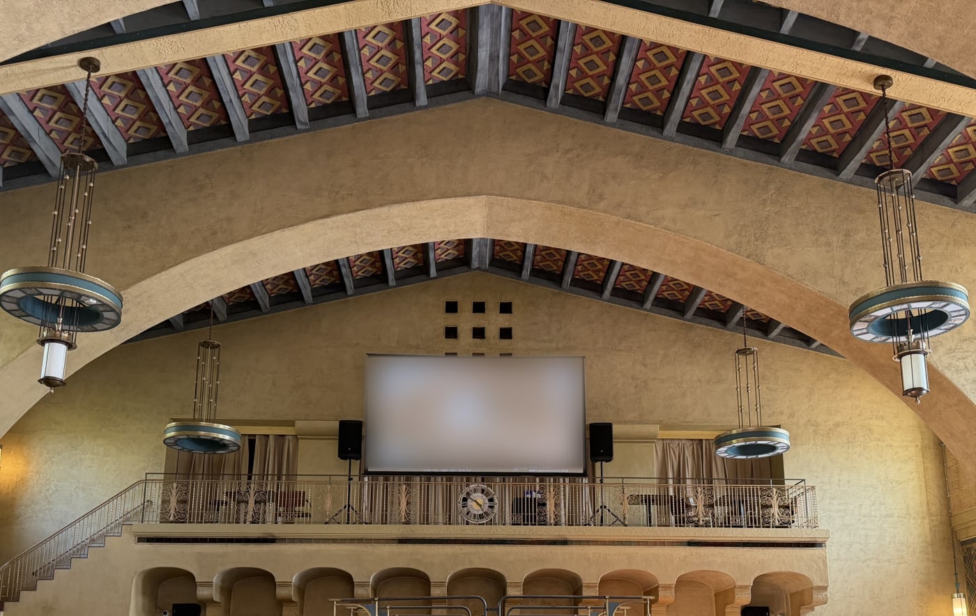 Projection screen and speakers on the balcony of a historic hall at Union Station, Los Angeles